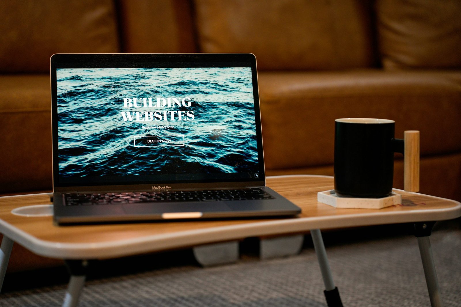 A website hero on a laptop beside a mug