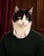 Kalle Tuxen: A tuxedo cat in a dark green sweater